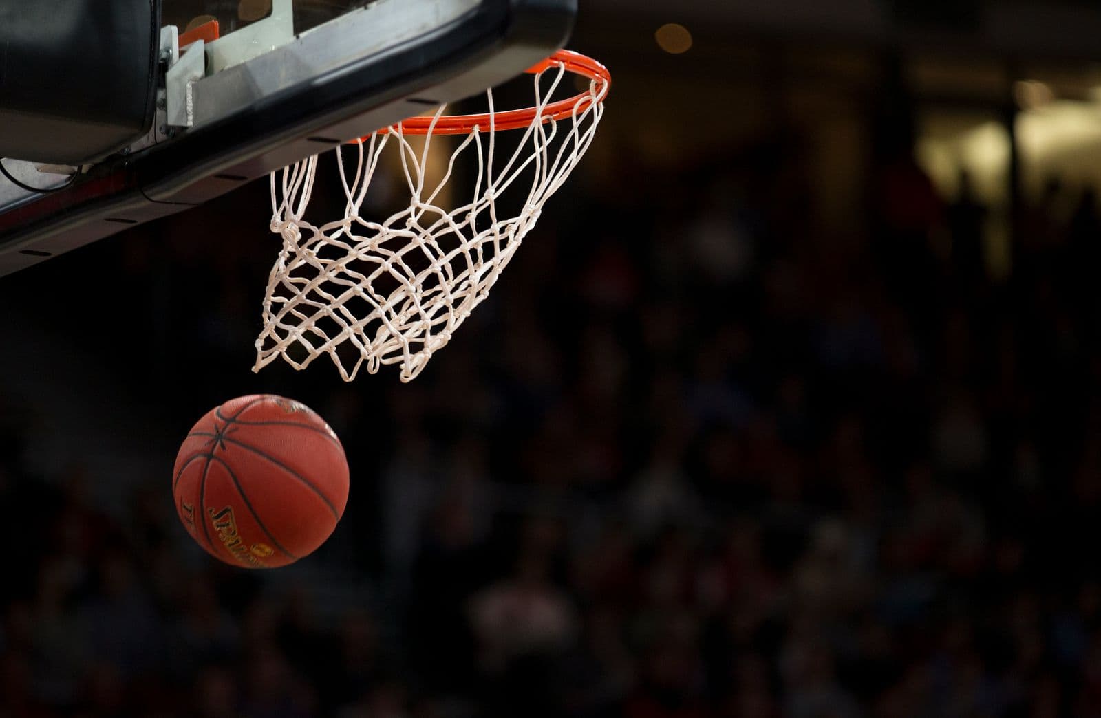 Basketball falling through a hoop
